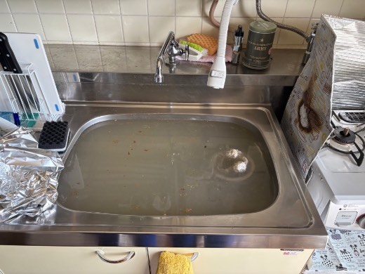 作業前のキッチンシンク。水が引かず濁った水がたまっている状態